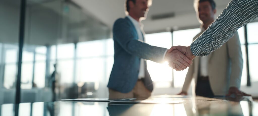Two people shaking hands in an office