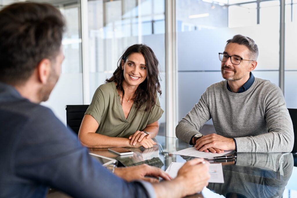 Two colleagues talking across a meeting table