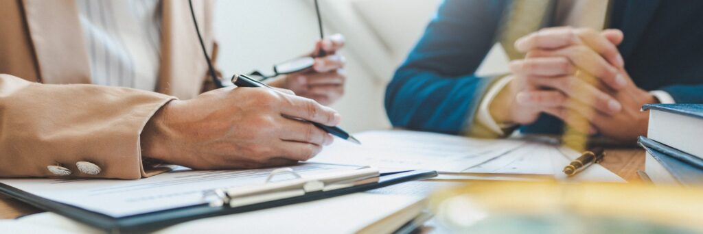 Two people reviewing documents at a desk